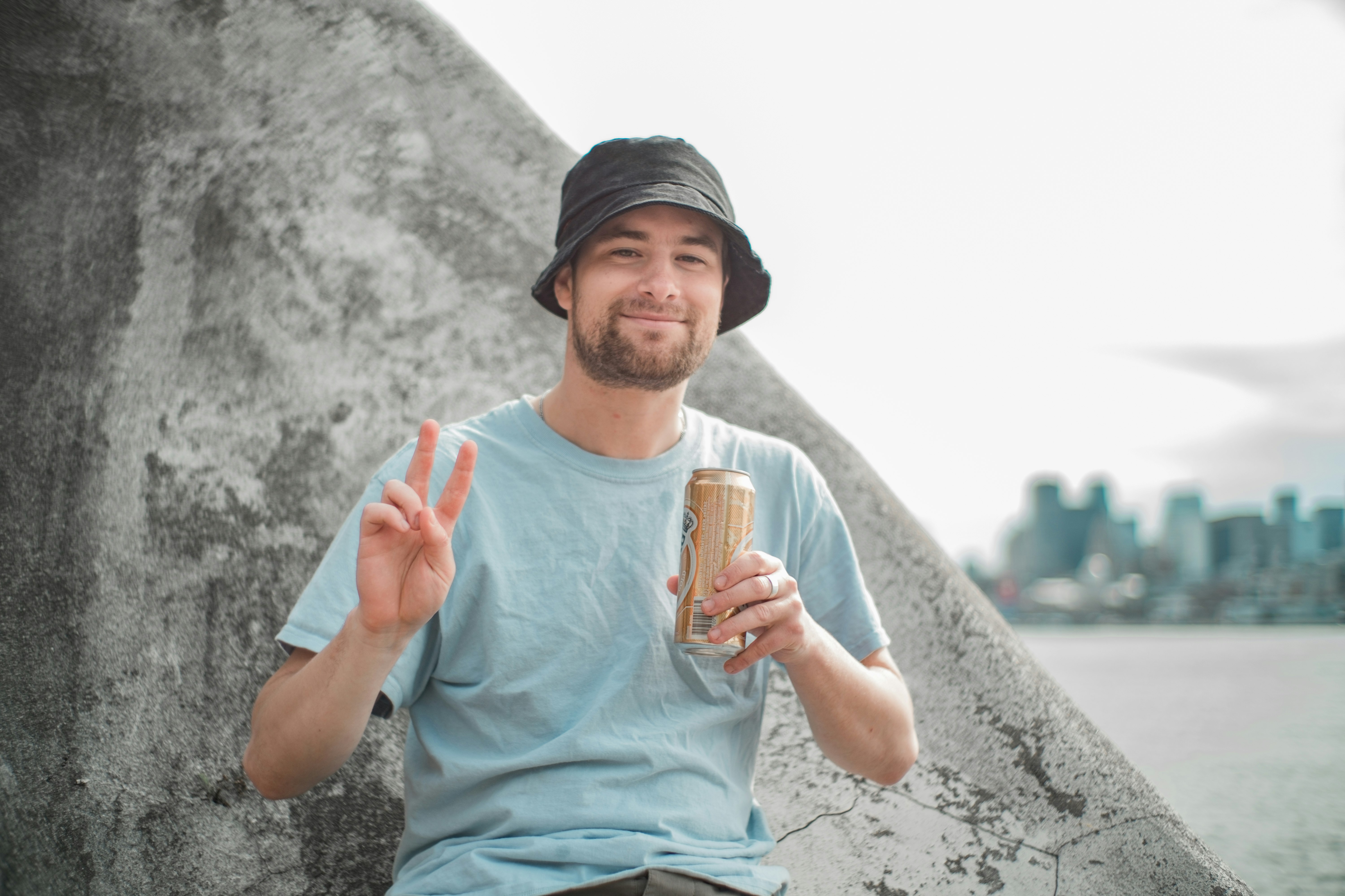 man in teal crew neck t-shirt holding ice cream cone